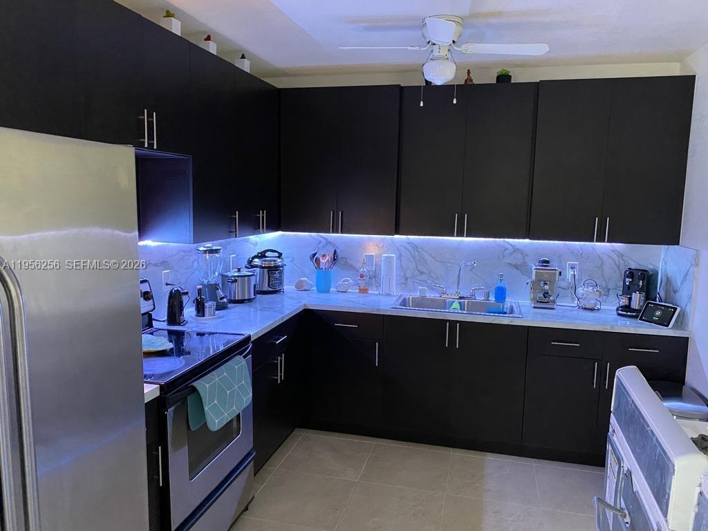 14680 Tyler Street Miami, FL 33176 - Photo 5 of 6 a kitchen with granite countertop cabinets and steel appliances