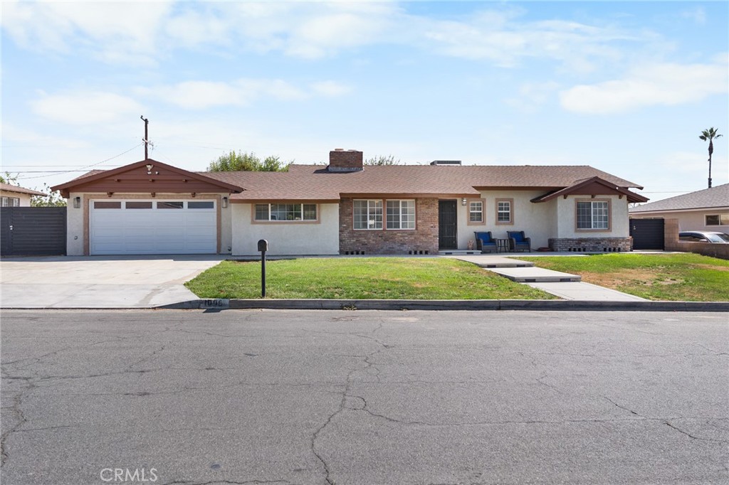 1005 North Encina Avenue Rialto, CA 92376 - Photo 1 of 39 a view of a house with a big yard and large trees