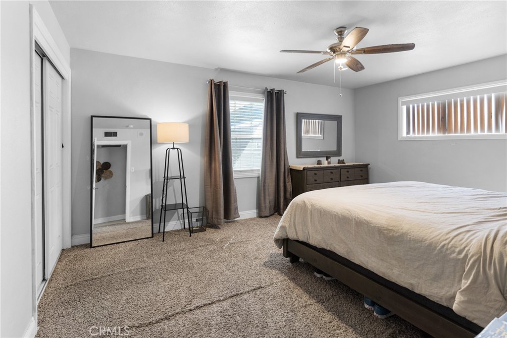 1005 North Encina Avenue Rialto, CA 92376 - Photo 19 of 39 a spacious bedroom with a bed and a chandelier