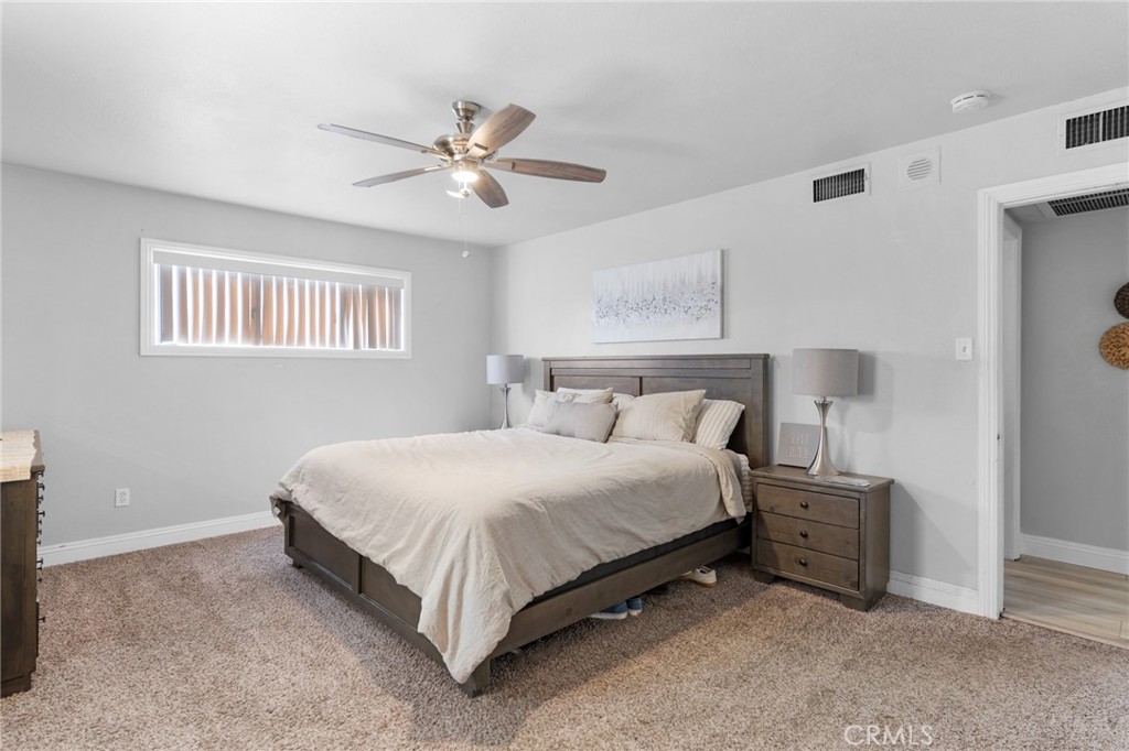 1005 North Encina Avenue Rialto, CA 92376 - Photo 21 of 39 a bedroom with a bed and a chandelier