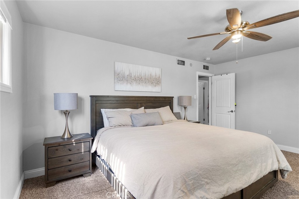 1005 North Encina Avenue Rialto, CA 92376 - Photo 22 of 39 a bedroom with a bed and a lamp