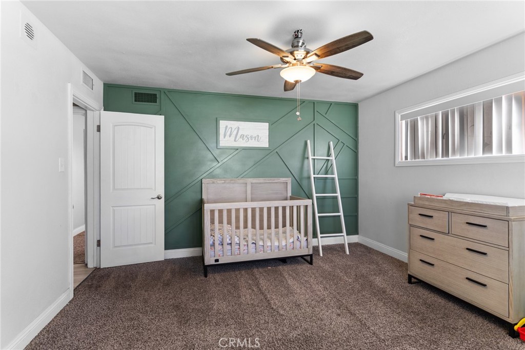 1005 North Encina Avenue Rialto, CA 92376 - Photo 27 of 39 a living room with furniture and a baby crib