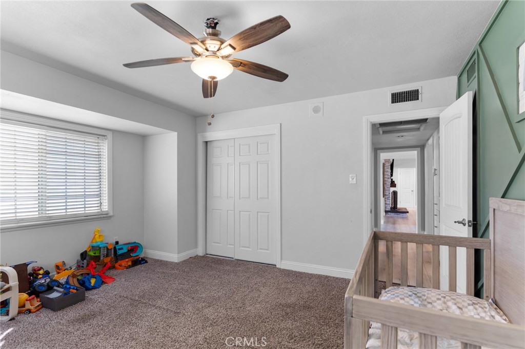 1005 North Encina Avenue Rialto, CA 92376 - Photo 28 of 39 a view of an empty room with a window and ceiling fan