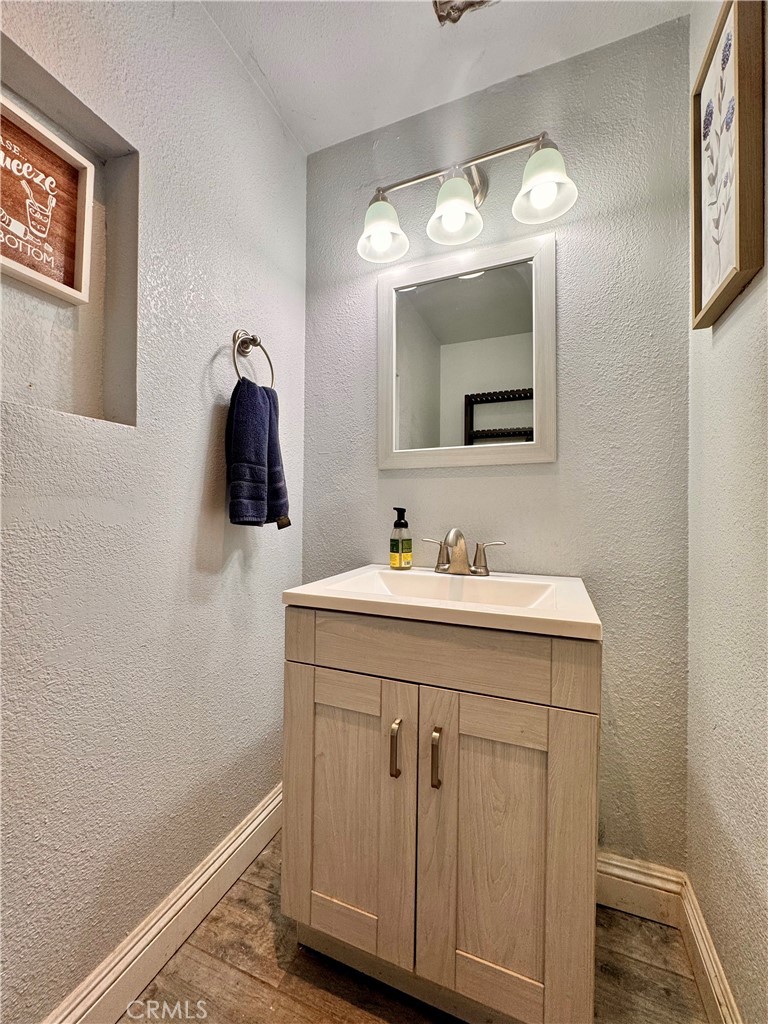 1005 North Encina Avenue Rialto, CA 92376 - Photo 29 of 39 a bathroom with a sink vanity and a mirror