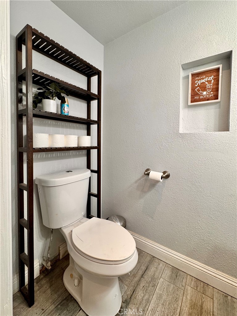 1005 North Encina Avenue Rialto, CA 92376 - Photo 30 of 39 a white toilet sitting next to a bathroom sink