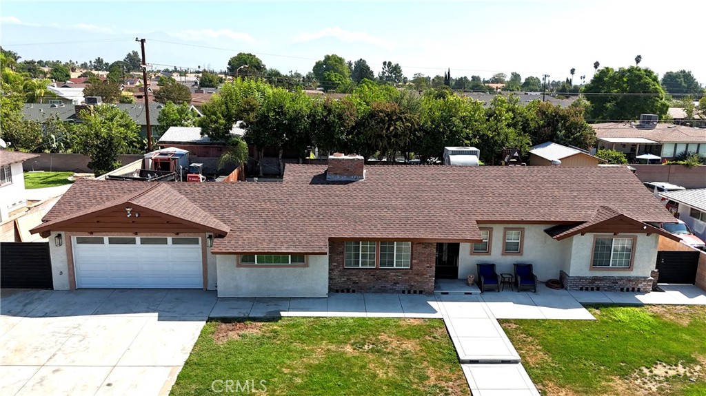 1005 North Encina Avenue Rialto, CA 92376 - Photo 3 of 39 a front view of a house with a yard table and chairs