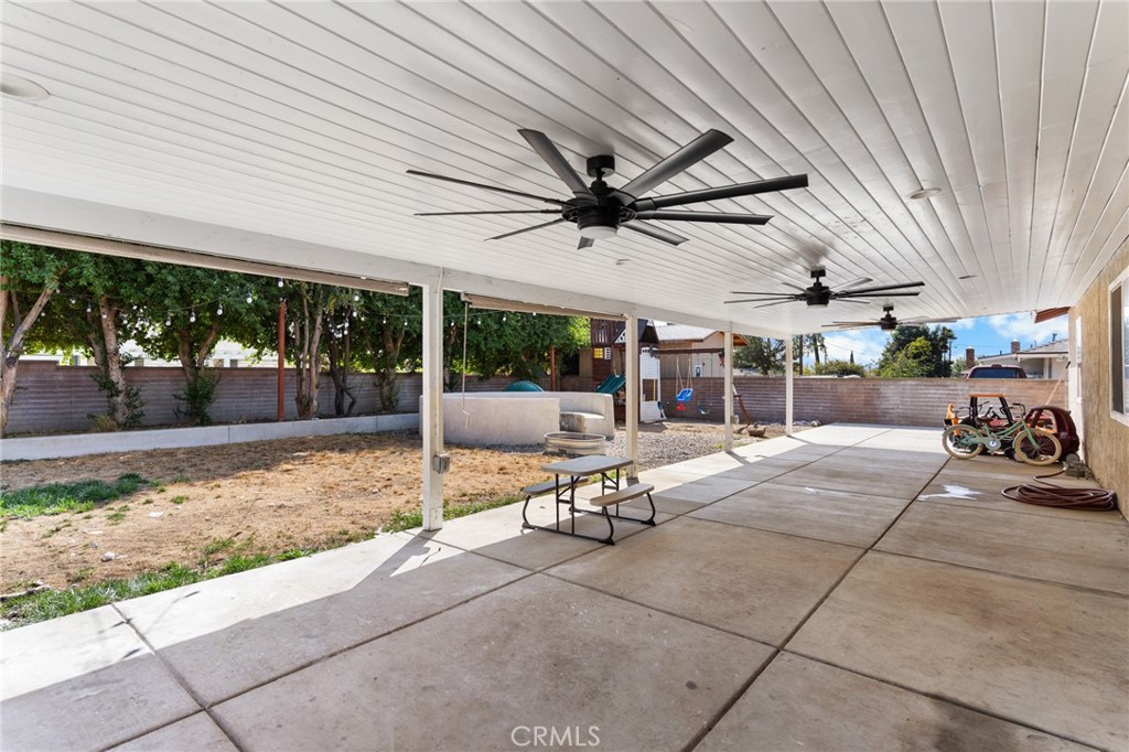 1005 North Encina Avenue Rialto, CA 92376 - Photo 31 of 39 a view of a patio with a table and chairs and potted plants