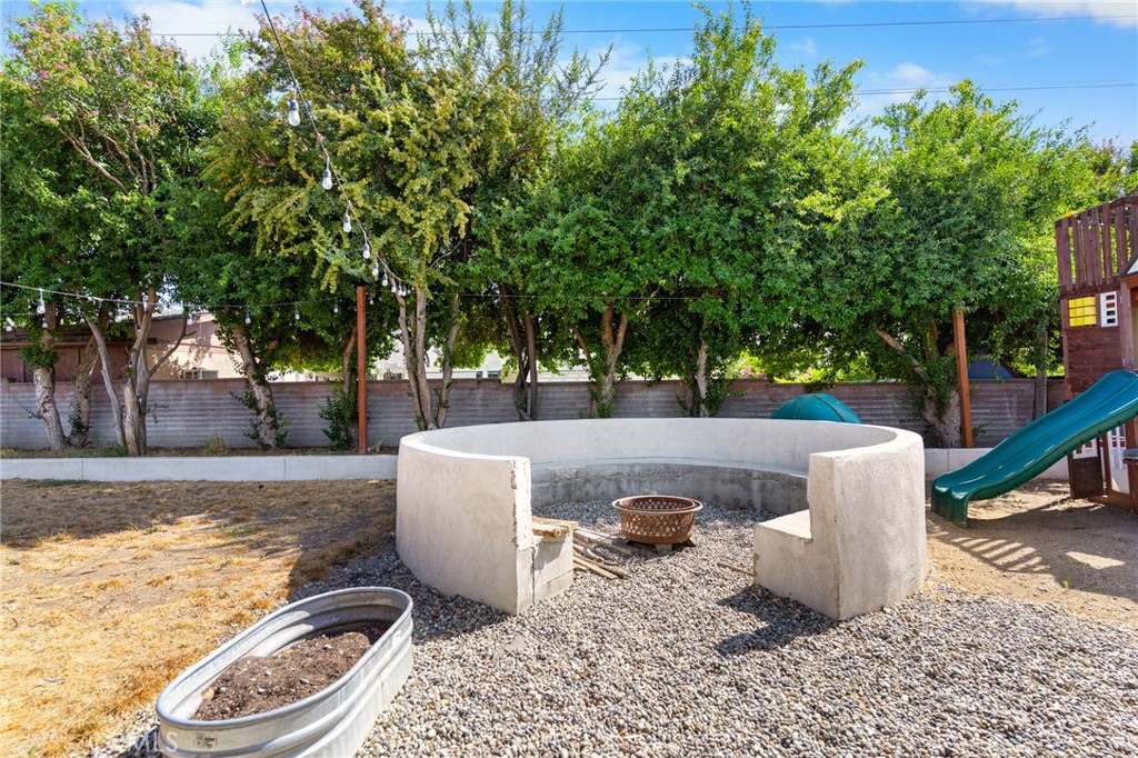 1005 North Encina Avenue Rialto, CA 92376 - Photo 34 of 39 a view of a white house and a yard