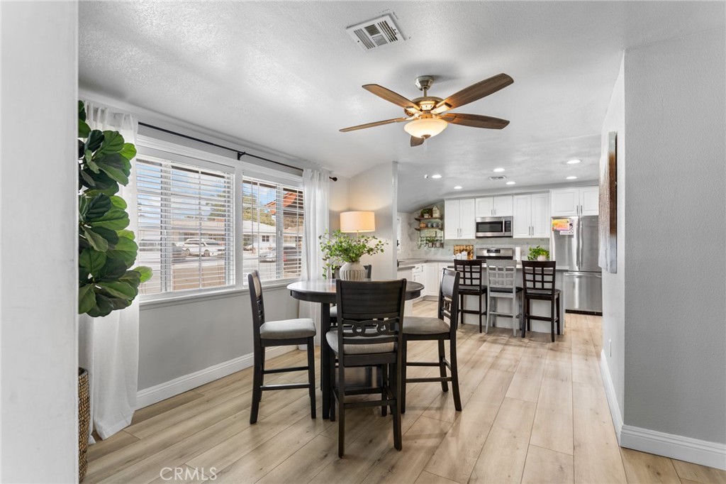 1005 North Encina Avenue Rialto, CA 92376 - Photo 6 of 39 a view of a dining room with furniture window and wooden floor