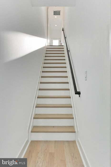 1313 Orren Street Northeast, Unit 3 Washington, DC 20002 - Photo 12 of 24 Bright and inviting staircase to upper levels.