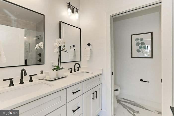 1313 Orren Street Northeast, Unit 3 Washington, DC 20002 - Photo 14 of 24 Elegant dual-sink bathroom with modern touches.