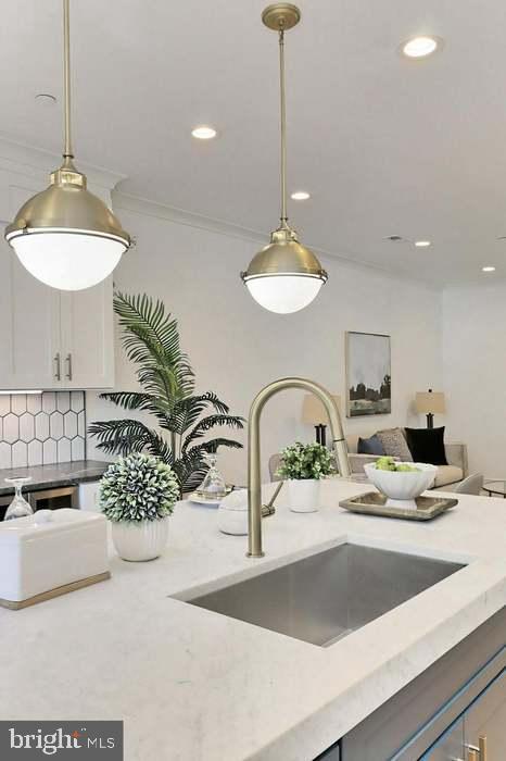 1313 Orren Street Northeast, Unit 3 Washington, DC 20002 - Photo 8 of 24 Modern kitchen with elegant lighting accents.