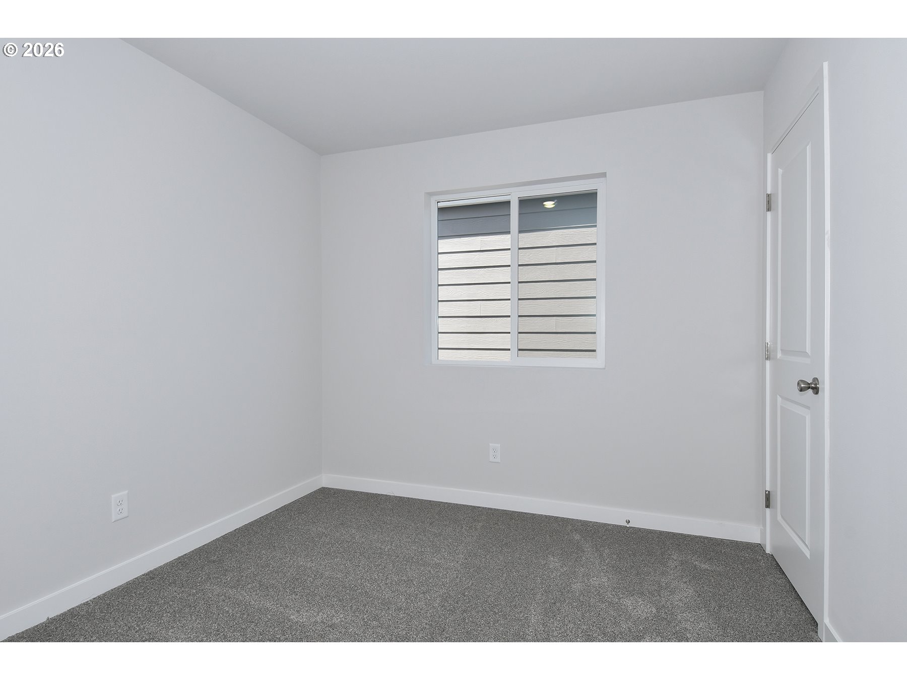 1175 Parkside Avenue Woodburn, OR 97071 - Photo 13 of 15 a view of an empty room with wooden floor and a window