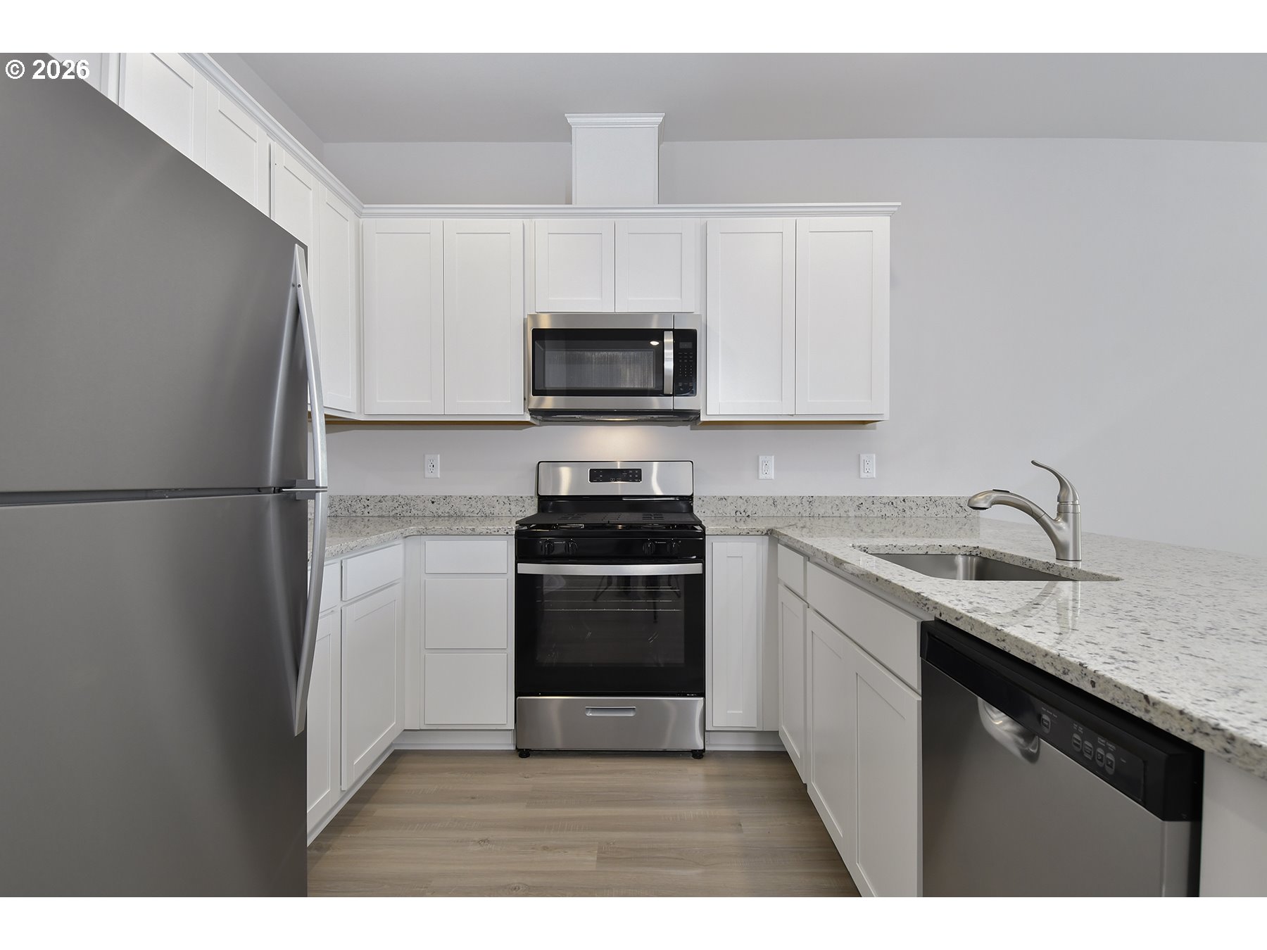 1175 Parkside Avenue Woodburn, OR 97071 - Photo 6 of 15 a kitchen with a sink a stove top oven and refrigerator
