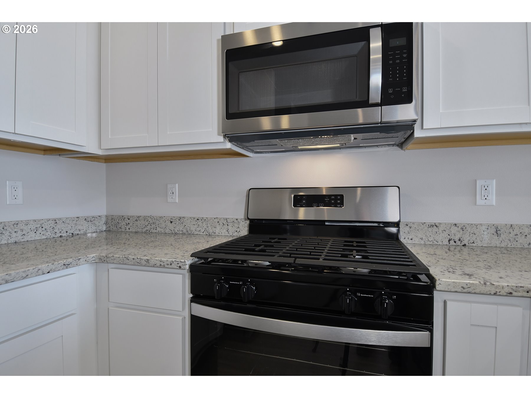 1175 Parkside Avenue Woodburn, OR 97071 - Photo 7 of 15 a kitchen with stainless steel appliances granite countertop white cabinets stove top oven and granite counter top