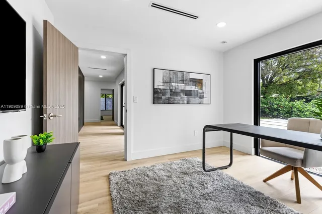 a living room with furniture wooden floor and a flat screen tv