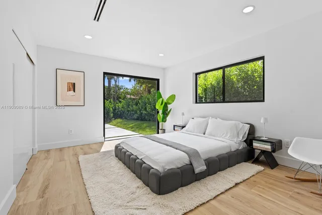 a bedroom with a large bed and a window