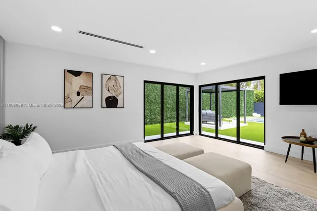 a bedroom with a large bed and a large window