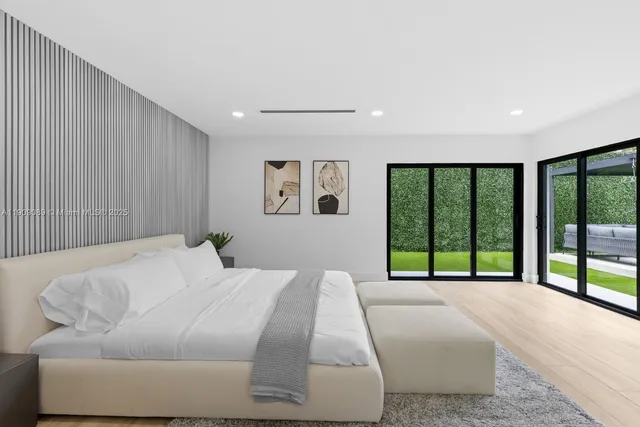 a bed sitting in a bedroom next to a large window