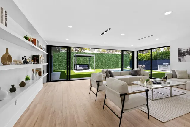 a living room with furniture and a large window with outer view