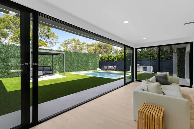 a bedroom with furniture and a large window