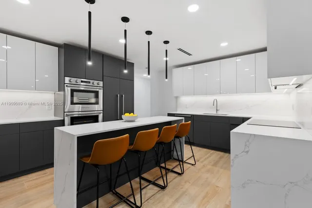 a kitchen with a table chairs microwave and cabinets