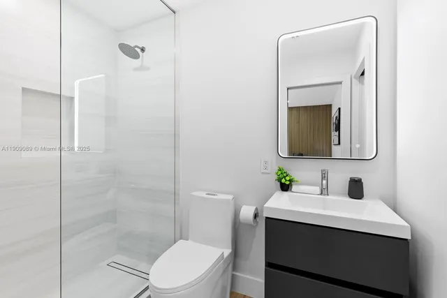 a bathroom with a toilet sink shower and mirror