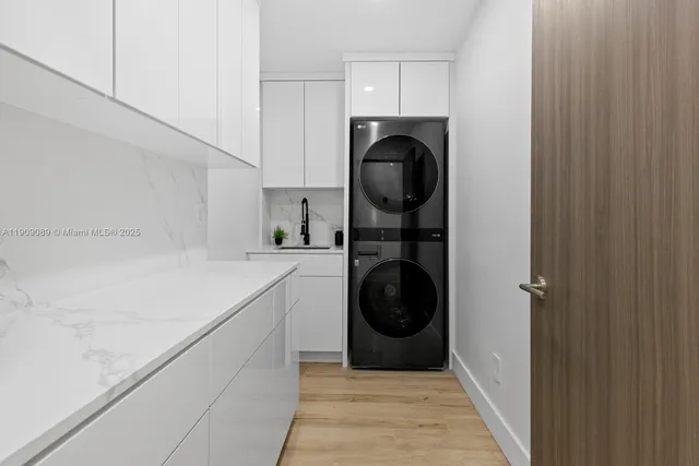 a utility room with sink dryer and washer