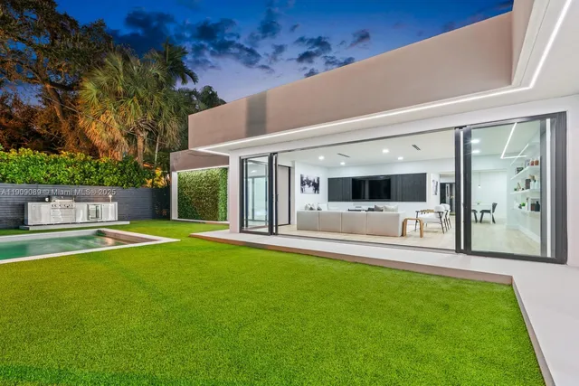 a view of a house with a backyard and a patio