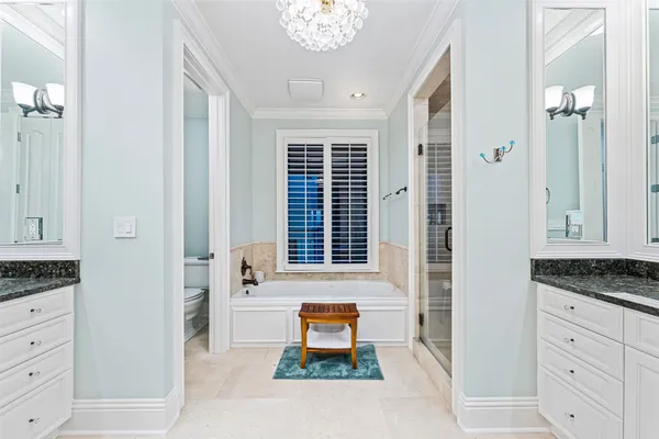 a spacious bathroom with a granite countertop sink mirror and shower