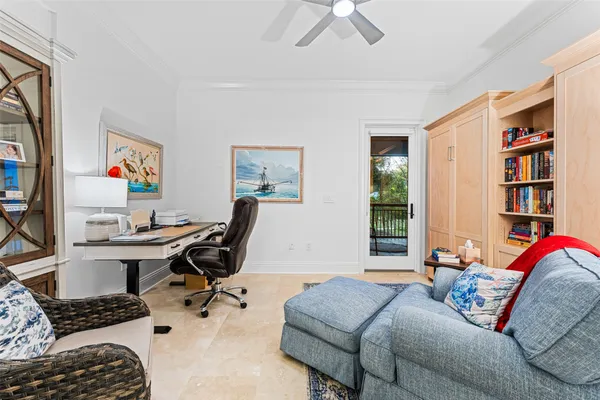 a living room with furniture and a floor to ceiling window