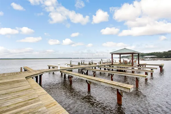 a view of a lake with a table and chairs