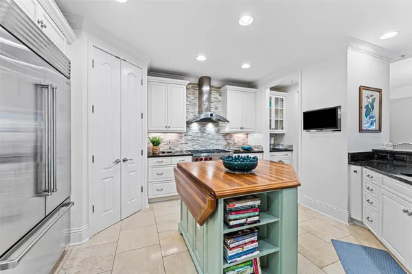 a kitchen with stainless steel appliances a stove sink and cabinets