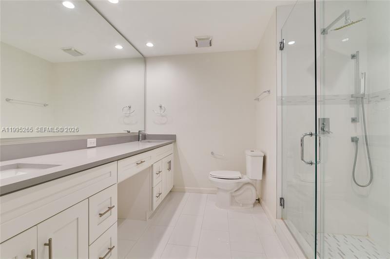 307 Bonnie Brae Way, Unit 26 Hollywood, FL 33021 - Photo 14 of 21 a bathroom with a granite countertop sink a toilet and a shower