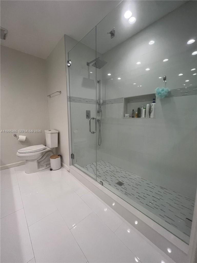 307 Bonnie Brae Way, Unit 26 Hollywood, FL 33021 - Photo 15 of 21 a bathroom with a sink a toilet and shower