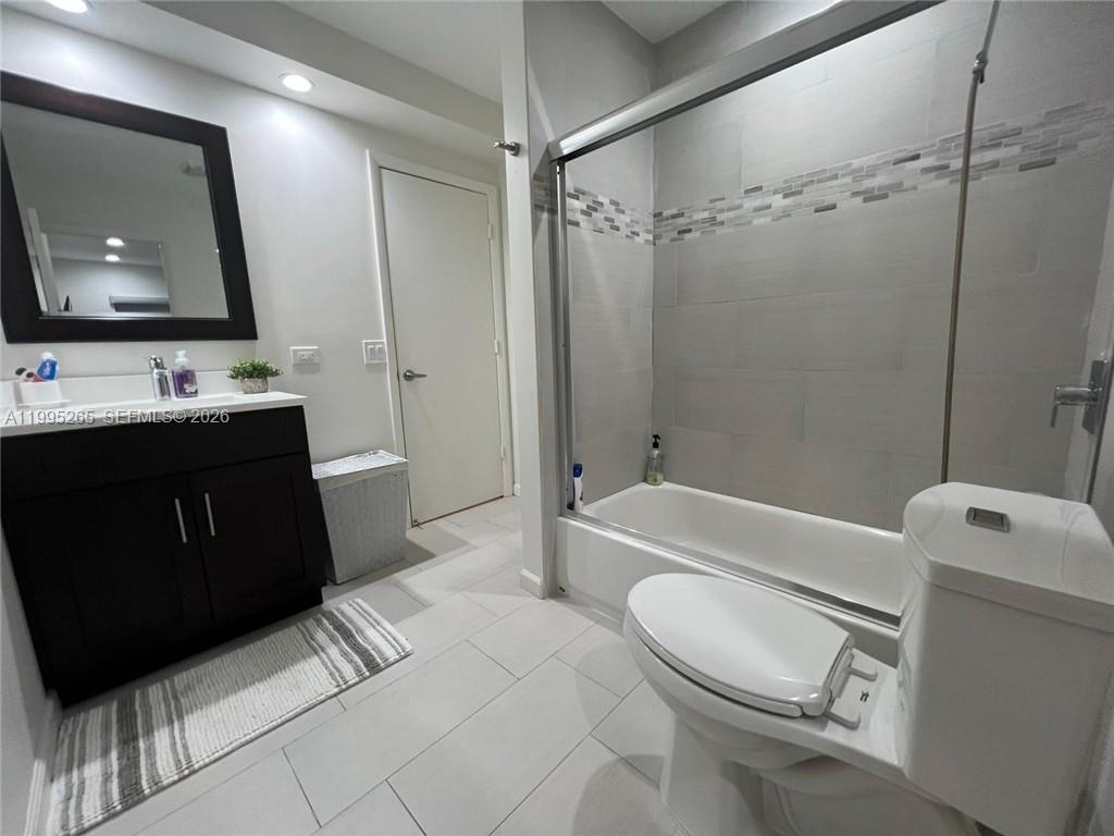 307 Bonnie Brae Way, Unit 26 Hollywood, FL 33021 - Photo 16 of 21 a bathroom with a sink a toilet a mirror a vanity a bathtub and shower