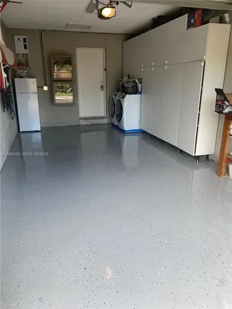a view of a hallway with workspace and a window