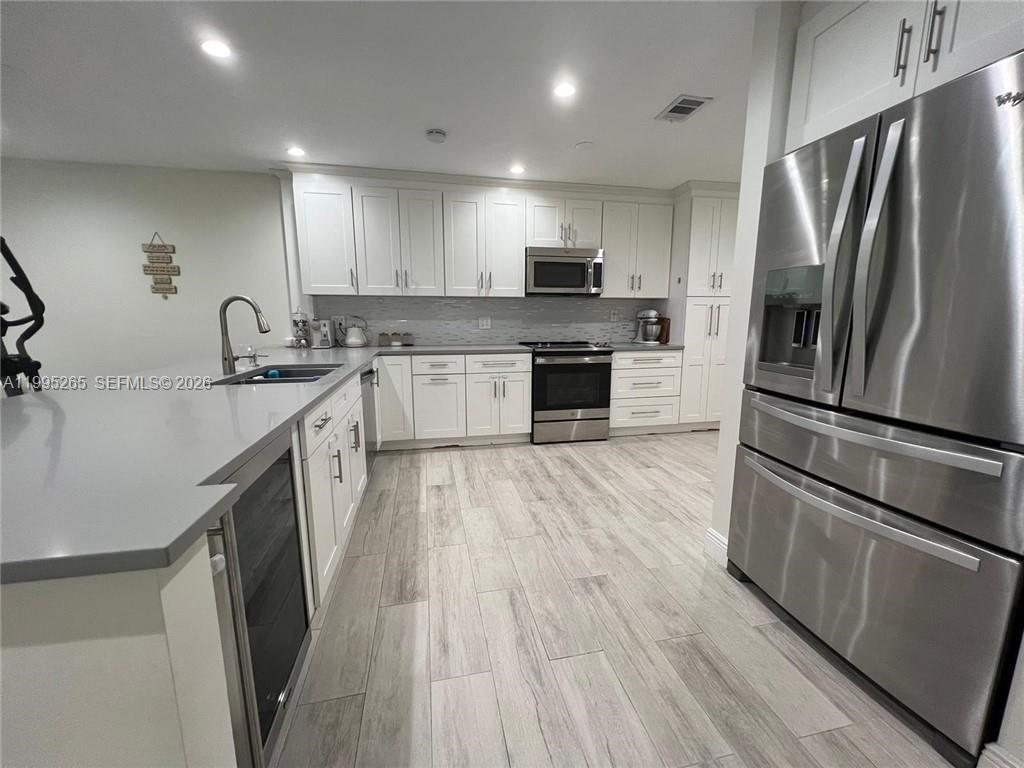 307 Bonnie Brae Way, Unit 26 Hollywood, FL 33021 - Photo 2 of 21 a kitchen with stainless steel appliances a refrigerator sink and microwave