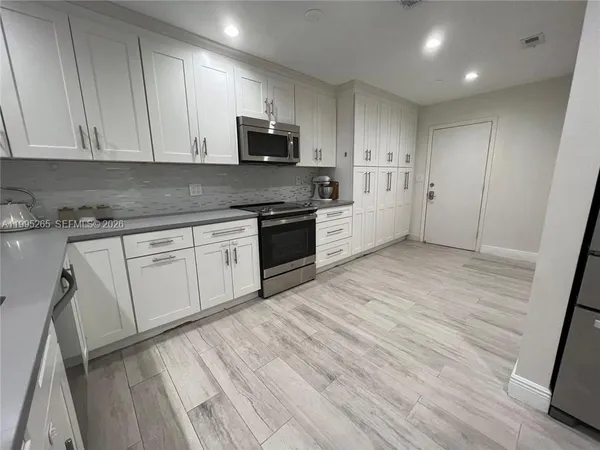 a view of a kitchen with electric appliances