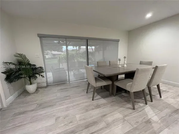 a dining room with furniture and wooden floor