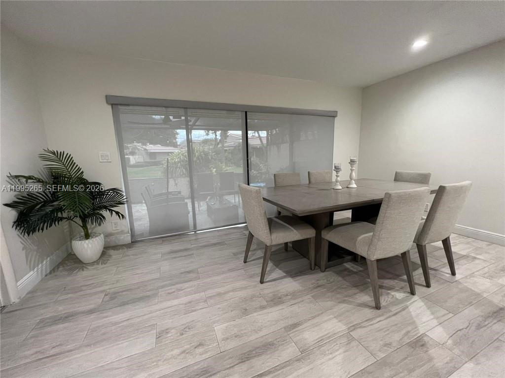307 Bonnie Brae Way, Unit 26 Hollywood, FL 33021 - Photo 7 of 21 a dining room with furniture and wooden floor