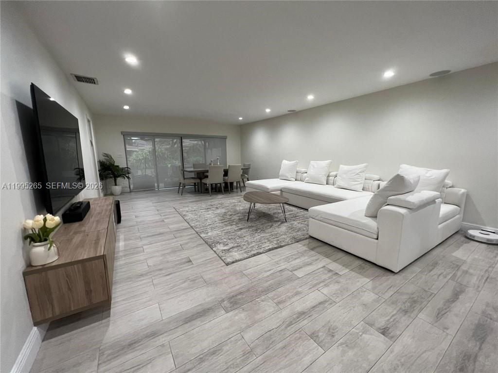 307 Bonnie Brae Way, Unit 26 Hollywood, FL 33021 - Photo 8 of 21 a living room with furniture and a flat screen tv