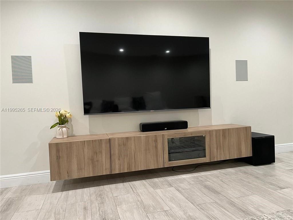 307 Bonnie Brae Way, Unit 26 Hollywood, FL 33021 - Photo 9 of 21 a living room with furniture and a flat screen tv