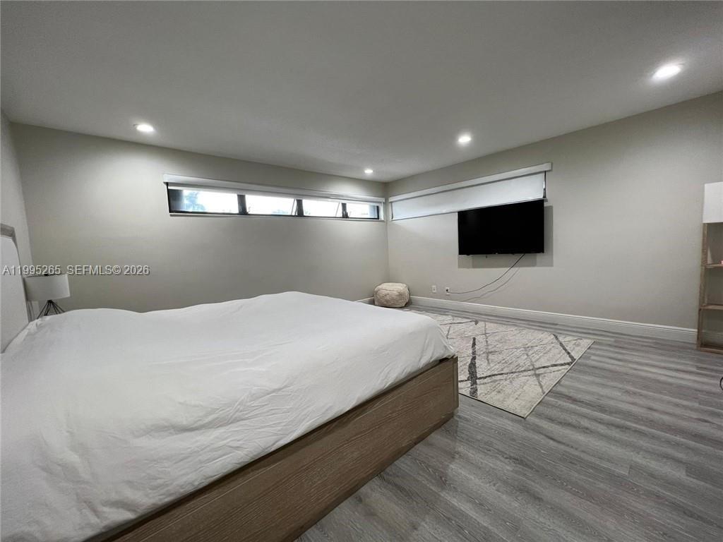 307 Bonnie Brae Way, Unit 26 Hollywood, FL 33021 - Photo 10 of 21 a bedroom with a bed and a flat screen tv