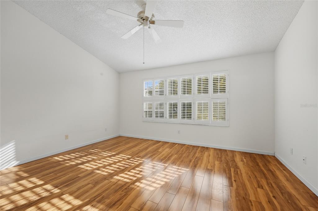 6029 Lake Pointe Drive, Unit 202 Orlando, FL 32822 - Photo 18 of 28 a view of an empty room with wooden floor and a window