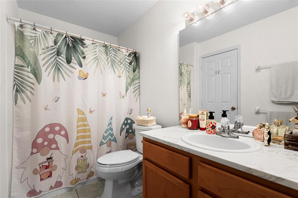 6029 Lake Pointe Drive, Unit 202 Orlando, FL 32822 - Photo 19 of 28 a bathroom with a sink and a mirror