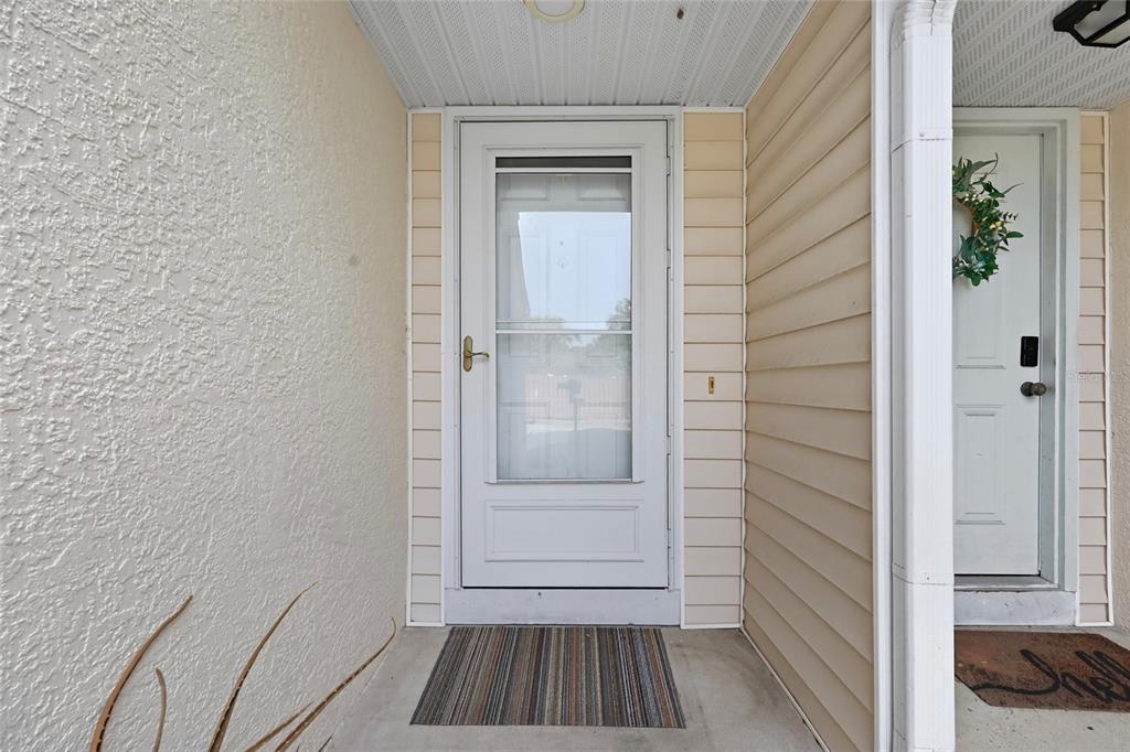 6029 Lake Pointe Drive, Unit 202 Orlando, FL 32822 - Photo 2 of 28 a view of a hallway with wooden floor and a bathroom