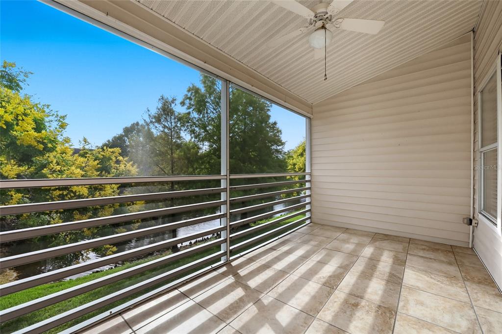 6029 Lake Pointe Drive, Unit 202 Orlando, FL 32822 - Photo 21 of 28 a view of a balcony with a floor to ceiling window and wooden floor