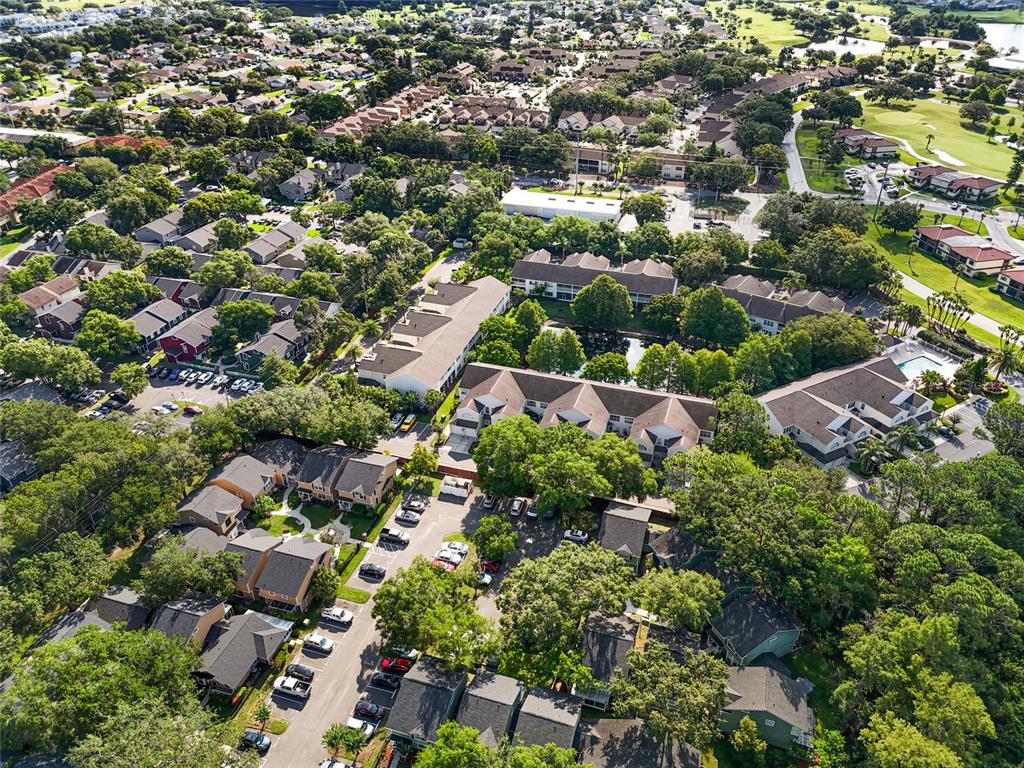 6029 Lake Pointe Drive, Unit 202 Orlando, FL 32822 - Photo 28 of 28 an aerial view of residential houses with outdoor space and trees