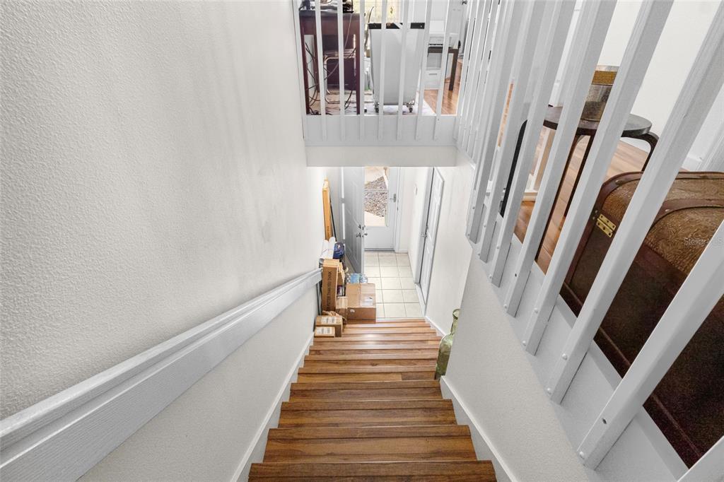 6029 Lake Pointe Drive, Unit 202 Orlando, FL 32822 - Photo 5 of 28 a view of a hallway with wooden floor and staircase